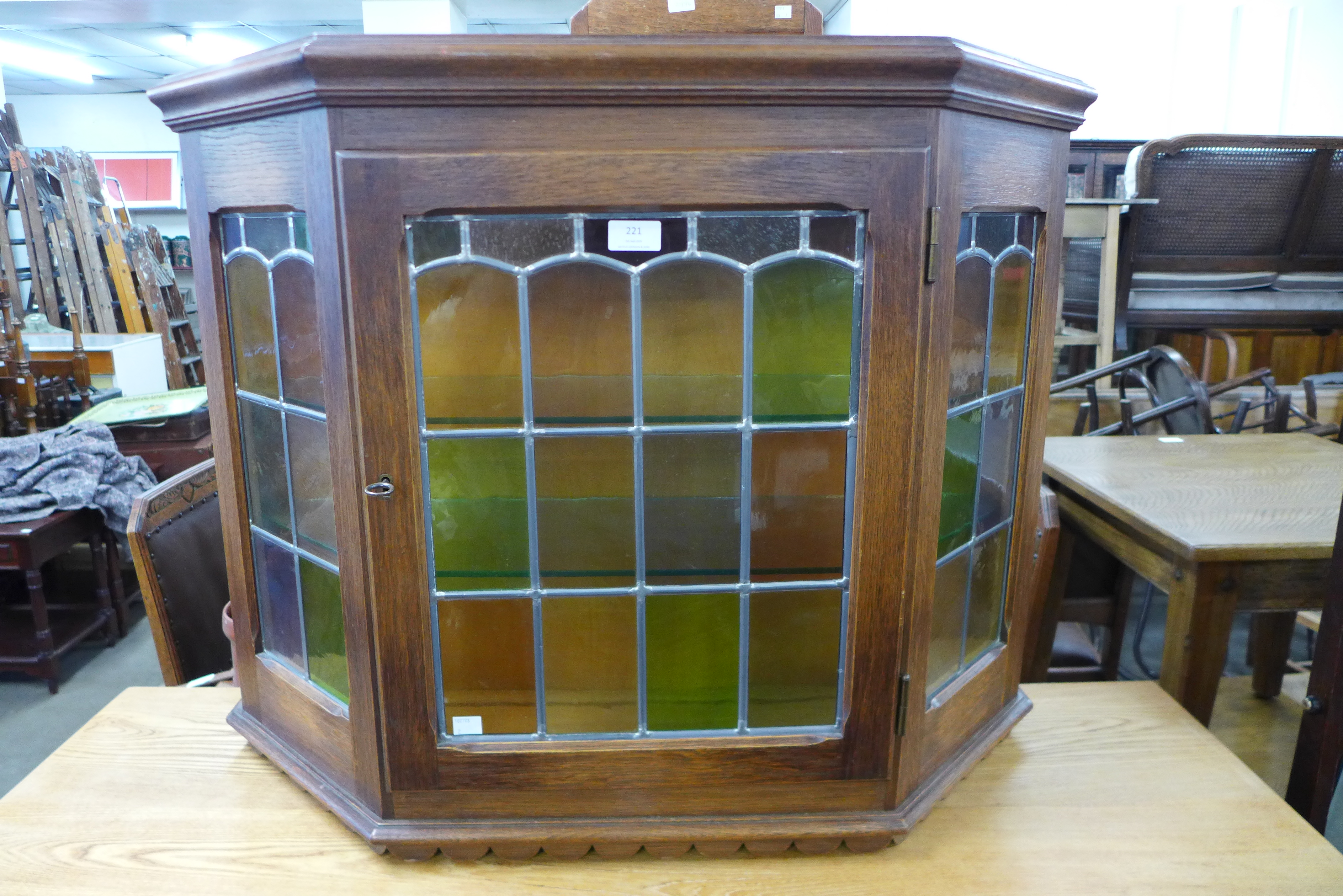 An oak and stained glass wall hanging cabinet