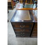 A mahogany and leather topped filing cabinet