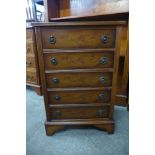 A small yew wood chest of drawers