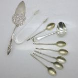 A pair of William IV silver sugar bows, a silver medicine spoon, six 800 silver spoons and an 830