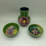A Moorcroft green vase, 11cm, and two similar green ground dishes