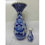 A large Japanese blue and white porcelain vase, decorated with flowers, 41cm, and a smaller