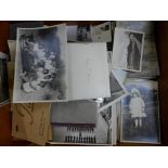 Approximately 100 postcards and a collection of photographs