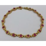 A 14k gold, ruby and diamond bracelet, 8.9g