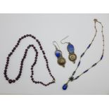 A pair of silver and lapis lazuli earrings, a blue necklace and a bead necklace