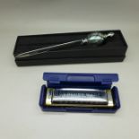 A Murano glass letter opener, with box and a Hohner Blues Harp, with box