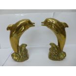 A pair of solid brass model dolphins