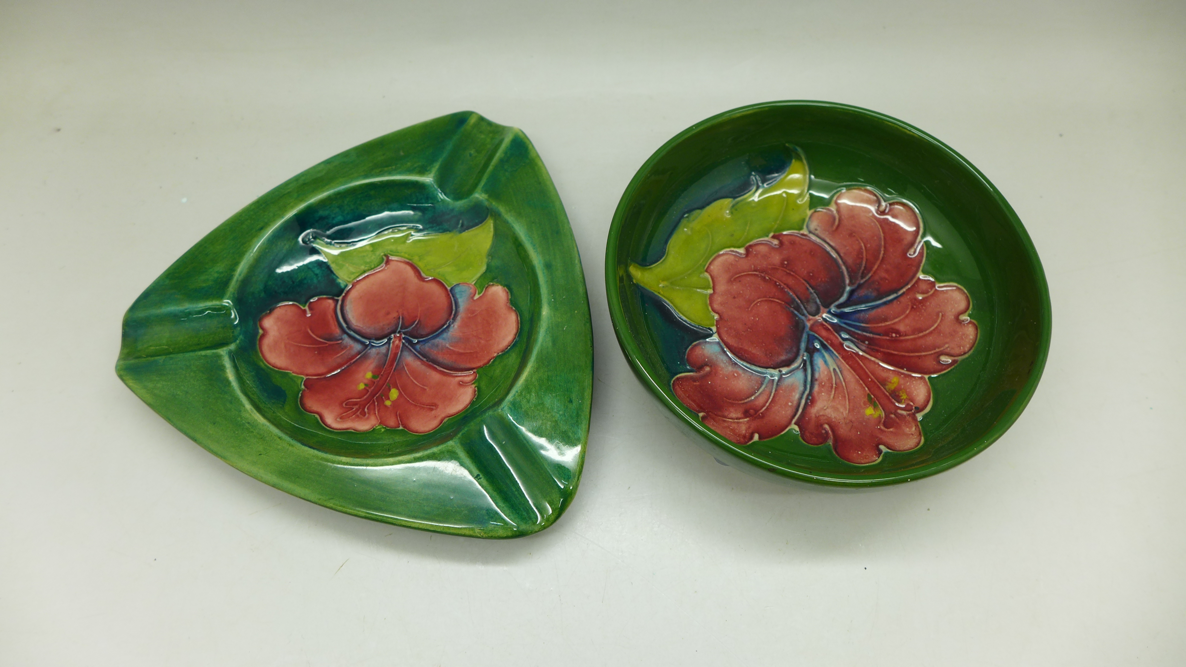 A Moorcroft dish and ashtray, green Hibiscus pattern, impressed marks to the base