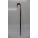 A bamboo walking cane with silver embellishments