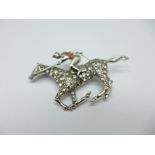 A silver and paste set horse and jockey brooch
