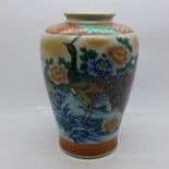 A Japanese vase decorated with peacocks in a garden landscape, 18cm