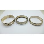 Three silver bangles, including one silver and one by Charles Horner