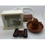 An ivory Bakelite electric mantel clock, a Bakelite orange squeezer, two scarf clips and a pair of