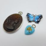 An enamel butterfly brooch, a silver pendant and a turquoise coloured heart pendant