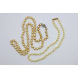 Two pearl necklaces, one with 9ct gold clasp, one with silver clasp