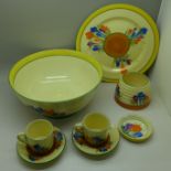 A Clarice Cliff Crocus pattern bowl, a/f, cracked, two coffee cans and saucers, small dish, plate