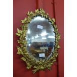 A Victorian cast gilt metal framed mirror, 47cms h