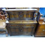 An Ercol Golden Dawn court cupboard