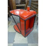 A red metal side table, made from a 1930's Ford car radiator