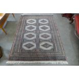 An eastern terracotta ground rug, 174 x 126cms