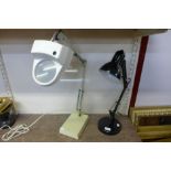 A black metal anglepoise lamp and a Luxo magnifier