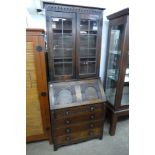 A carved oak bureau bookcase