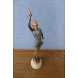 An Art Deco painted spelter figure of a lady, on onyx and marble socle