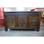 A carved oak blanket box