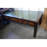 A mahogany and leather topped three drawer coffee table