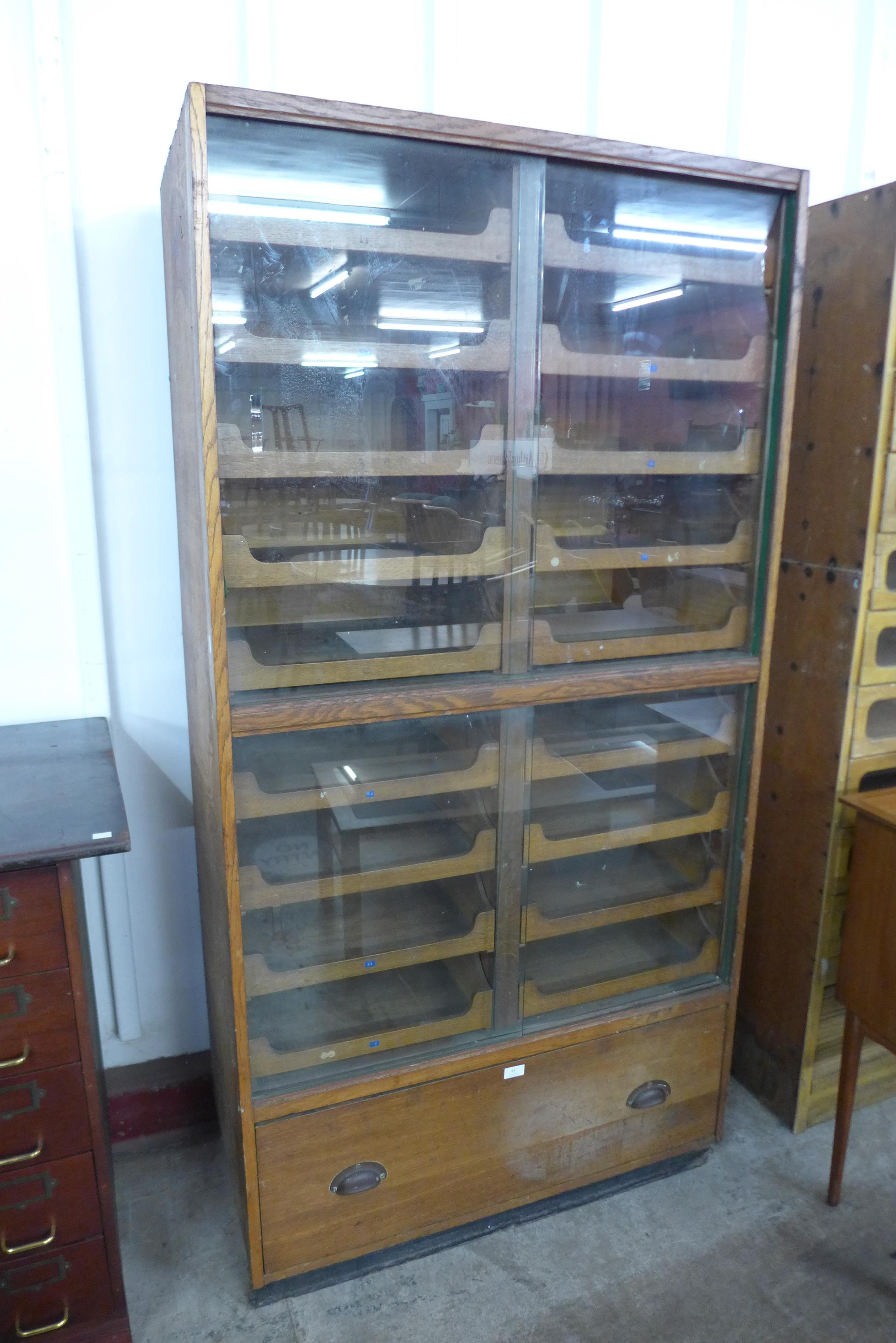 An early 20th Century oak haberdashery shop cabinet, 188cms h, 94cms w, 52cms d - Image 2 of 2