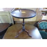 An inlaid mahogany tripod wine table