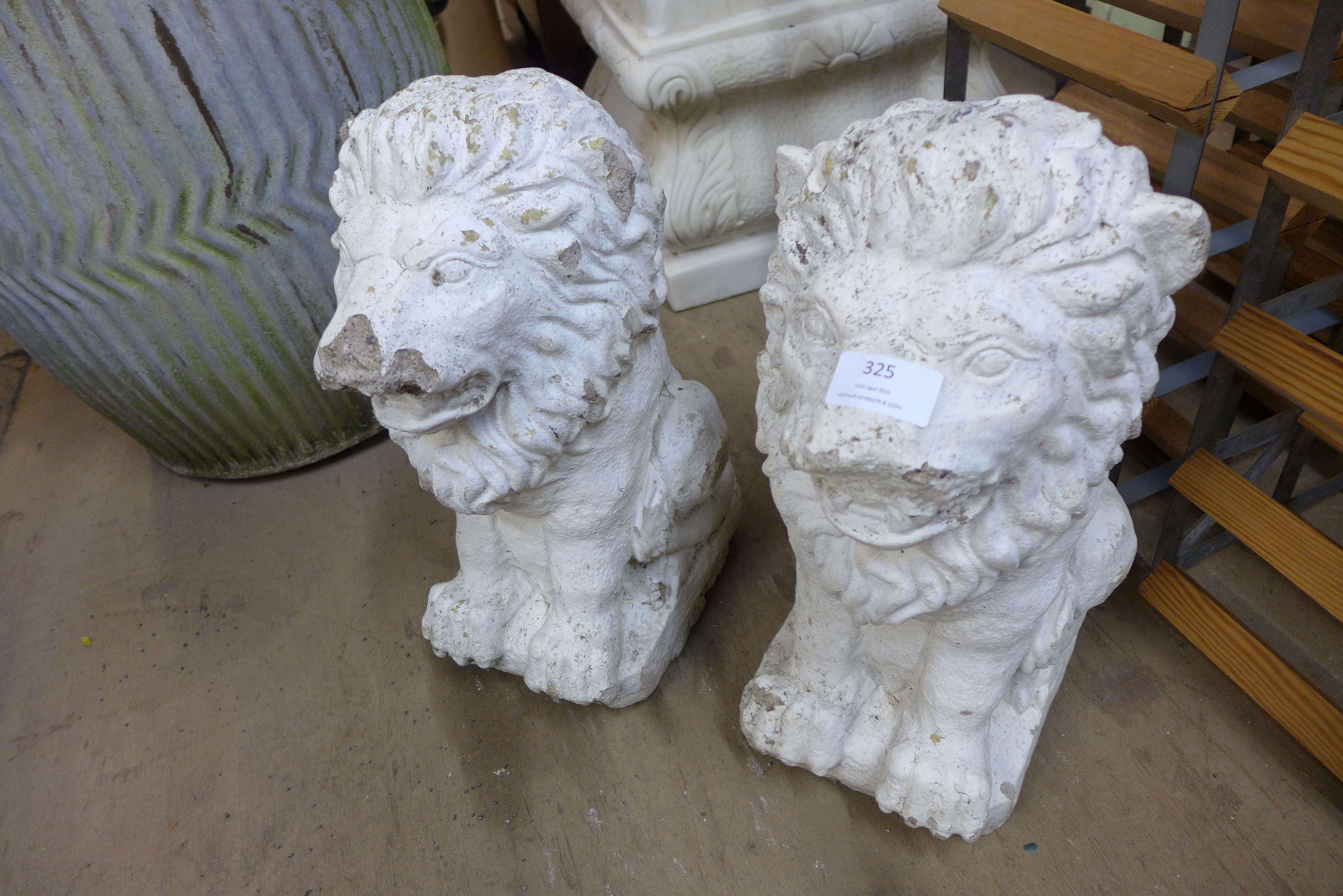 A pair of painted concrete garden lions