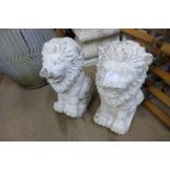 A pair of painted concrete garden lions