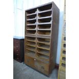 An early 20th Century oak haberdashery shop cabinet, 188cms h, 94cms w, 52cms d