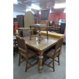 An oak draw-leaf dining table and four chairs