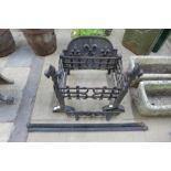 A pair of wrought and cast iron andirons and fire grate