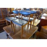 A set of four teak dining chairs