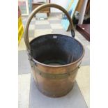 An Arts and Crafts brass and copper coal bucket