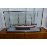 A Danmark model three mast ship, cased, 65cms h, 113cms w, 36cms d