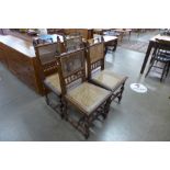 A set of four 19th Century Flemish carved oak bergere dining chairs