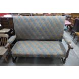 A 1930's oak and upholstered settle