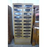 An early 20th Century beech haberdashery shop cabinet, 190cms h, 81cms w, 49cms d