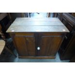 A Victorian pine table top two door cupboard