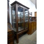 An early 20th Century oak shop display cabinet, 186cms h, 119cms w, 46cms d