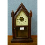 A 19th Century American Waterbury Clock Co. rosewood shelf clock