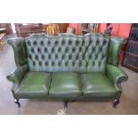 A green leather Chesterfield settee