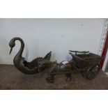 A cast metal horse and cart and a metal swan planter