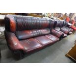 A red leather three piece suite