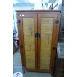 A Chinese hardwood and bamboo cupboard
