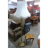 A brass Corinthian column standard lamp and an Italian musical table